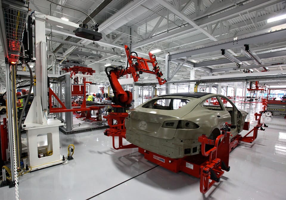 Industrial production hall with light floors and robotic equipment