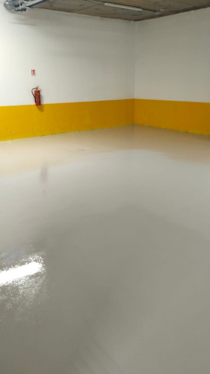 Epoxy car park floor with yellow wall base